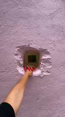 Visitors interact with pink wall art installation in Kuala Lumpur