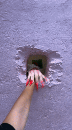 Visitors interact with pink wall art installation in Kuala Lumpur