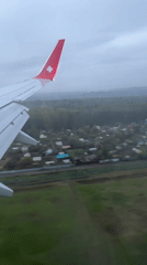 Passenger documents flight views over Russian countryside with star-emblemed aircraft