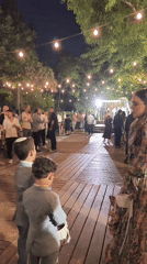 Outdoor wedding reception in Hulda with vintage VW vans and string lights