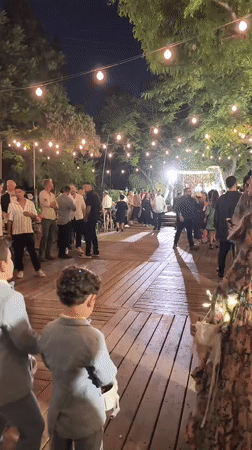 Outdoor wedding reception in Hulda with vintage VW vans and string lights