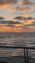 Sunset captured over Tel Aviv coastline with dramatic cloud formations