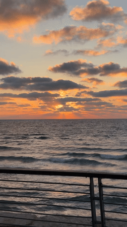 Sunset captured over Tel Aviv coastline with dramatic cloud formations