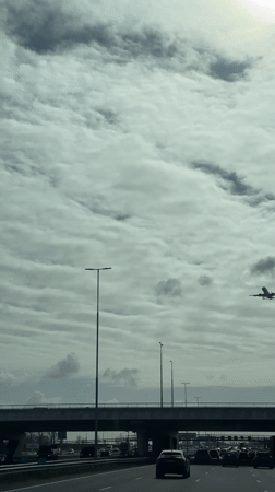 Commercial jet spotted flying over busy highway near Hoofddorp