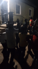 Nighttime community gathering features dancing, live drums in Nigeria