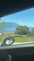 Driver captures scenic views of Budva coastline from moving car