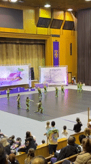 Young dancers perform at competition venue for seated audience