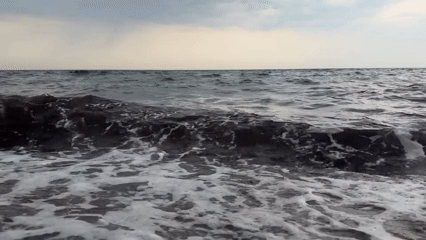 Baltic coast evening: stormy seas give way to a red sunset