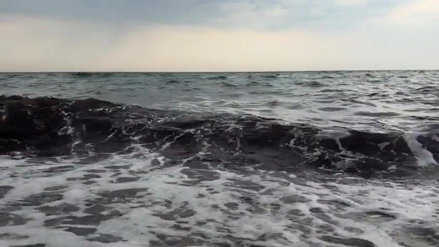 Baltic coast evening: stormy seas give way to a red sunset