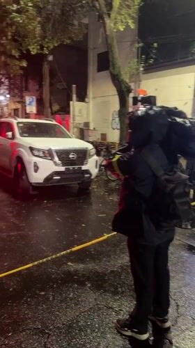 Emergency response scene documented on wet Mexico City street