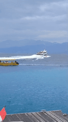 Morning boat traffic and passenger activity at Indonesian port