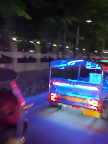 Bangkok nighttime traffic with illuminated tuk-tuks captured by witnesses
