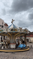 Tourist carousel and train operate in Colmar square
