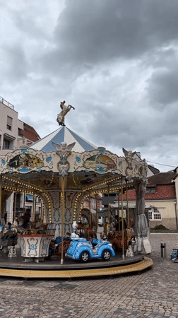 Tourist carousel and train operate in Colmar square
