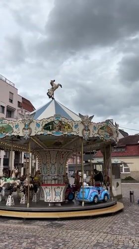 Tourist carousel and train operate in Colmar square