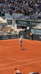 Tennis match at Roland Garros features player in blue uniform