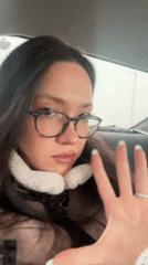 Person displays long white nails inside vehicle in Yerevan