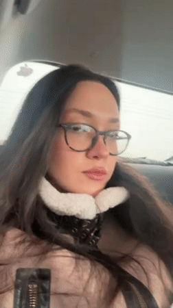 Person displays long white nails inside vehicle in Yerevan