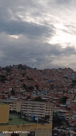 Evening documentation captures Caracas hillside neighborhoods under overcast skies