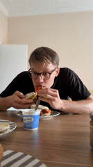 Man enjoys prosciutto sandwich at Catania restaurant