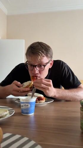 Man enjoys prosciutto sandwich at Catania restaurant