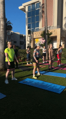Women practice yoga outdoors in scenic urban setting