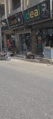Morning street scene captured in Quetta showing hair salons, motorcycles