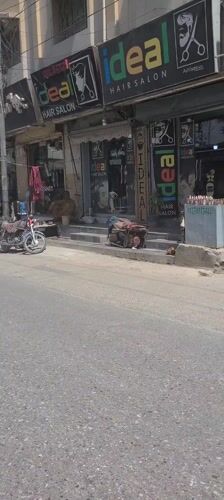 Morning street scene captured in Quetta showing hair salons, motorcycles