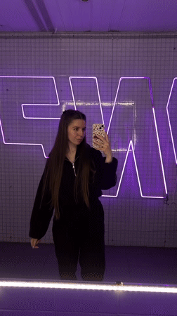 Woman records selfie videos in modern interior space, Klin Russia