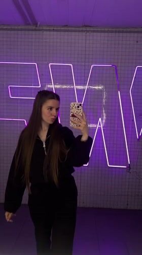 Woman records selfie videos in modern interior space, Klin Russia