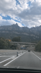 Motorist captures mountain scenery on highway near Montserrat, Spain