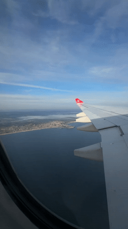 Aerial view captures Turkish coastal town from airline passenger window