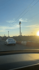 Sunset drive captures Kyiv skyline from elevated roadway