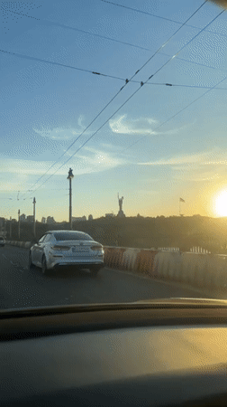 Sunset drive captures Kyiv skyline from elevated roadway