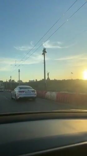 Sunset drive captures Kyiv skyline from elevated roadway
