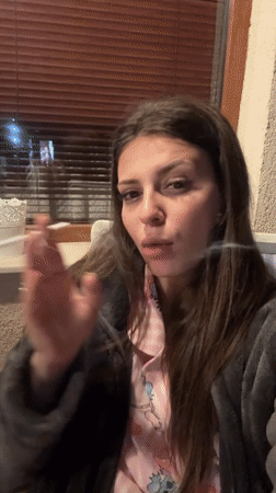 Woman takes evening selfies in Velingrad, Bulgaria
