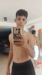 Young men take mirror selfies at Playa El Agua