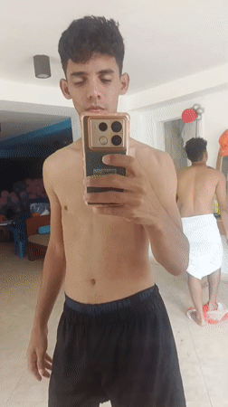 Young men take mirror selfies at Playa El Agua