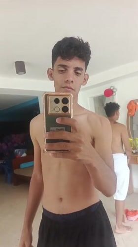 Young men take mirror selfies at Playa El Agua