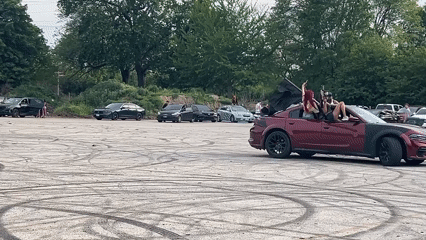 Red car does donuts in Chicago parking lot