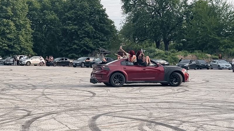 Red car does donuts in Chicago parking lot