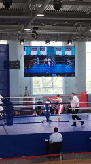 Boxing match between blue and red competitors in Kopeysk arena