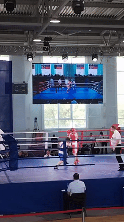 Boxing match between blue and red competitors in Kopeysk arena