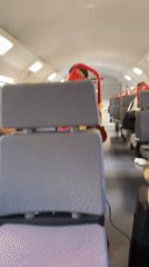 Street musician performs violin act on Spanish passenger train