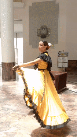 Woman in elaborate makeup dances in Venezuelan lobby