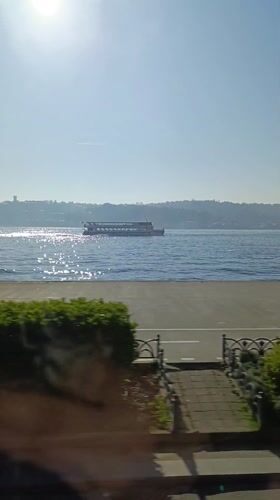 Ferry crosses sunny Bosphorus Strait near Sarıyer, Istanbul