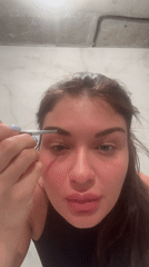 Woman applies eyebrow makeup in Khimki, Russia