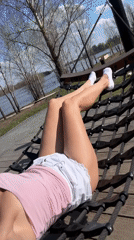 Woman enjoys sunny morning relaxation at Sarapul waterfront