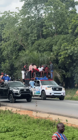 Vehicle procession with passengers travels through Akwanga, Nigeria