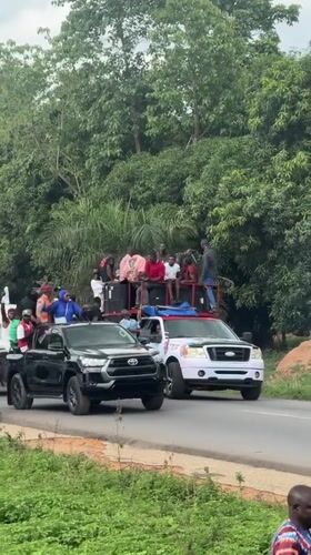 Vehicle procession with passengers travels through Akwanga, Nigeria